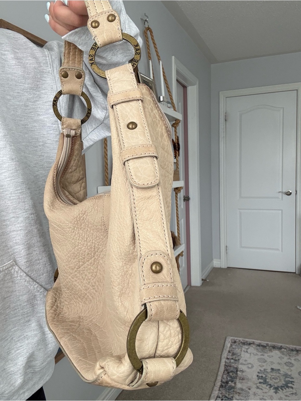 The Sak Cream Leather Hobo with Brass Ring Accents